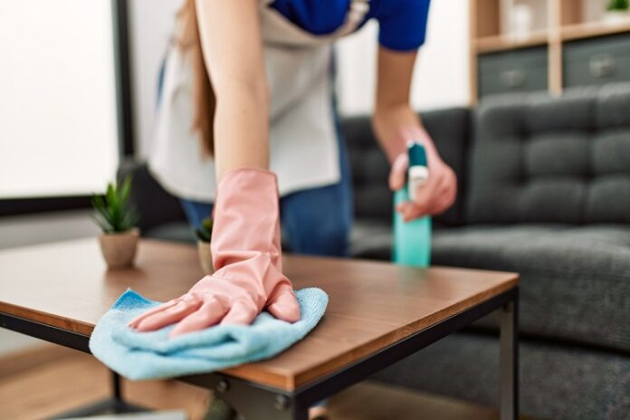 Woman,Cleaning,Table,Using,Rag,And,Diffuser,At,Home. Cleaning Service